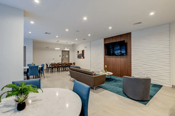 a living room with a table and chairs and a television